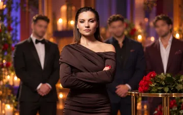 Actress Antonina Khyzhniak in a dark dress surrounded by reality show contestants