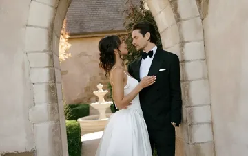 Actor Ben Barnes and artist Aubrey Cleland during their wedding ceremony under an archway