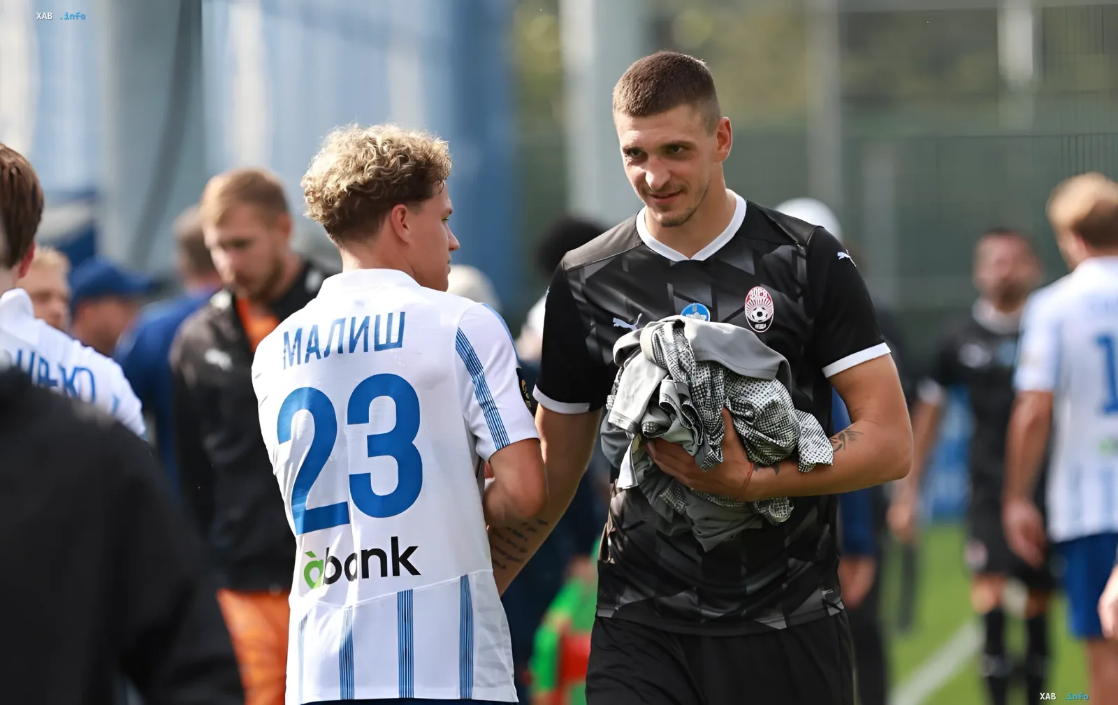 Pylyp Budkivskyi wearing the Zorya Luhansk jersey talking to a teammate after a match