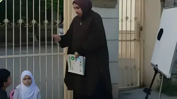 Teacher conducting a street lesson on the sidewalk in Azerbaijan due to hijab ban