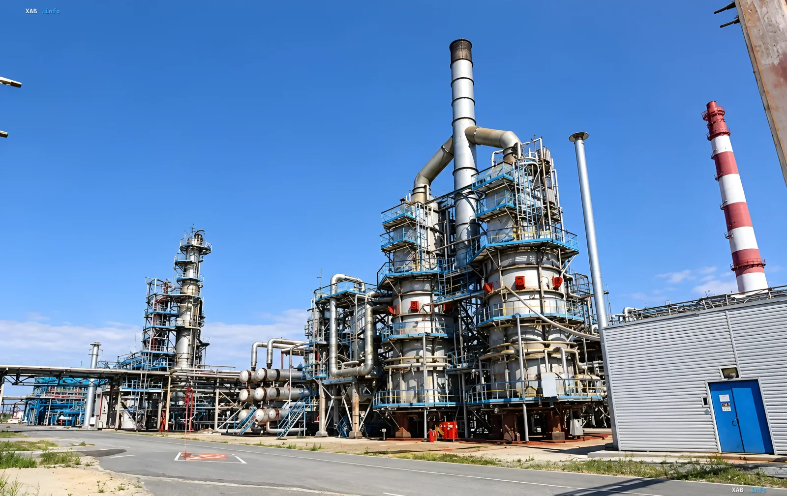 Industrial complex of a Gazprom plant with stabilization columns and pipes under a clear sky