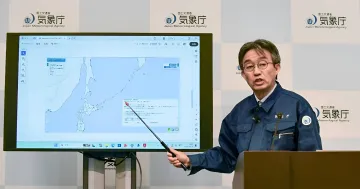 JMA division head Ayataka Ebita holds a press conference regarding the 9.9 magnitude false earthquake alarm in Japan