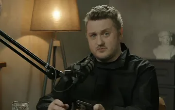Ex-head of CPD Andriy Kovalenko speaks on a podcast in a studio