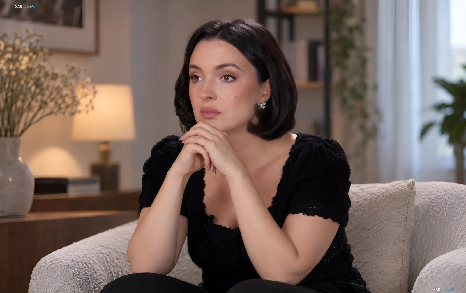 Woman with dark hair sitting in an armchair and sharing a personal story