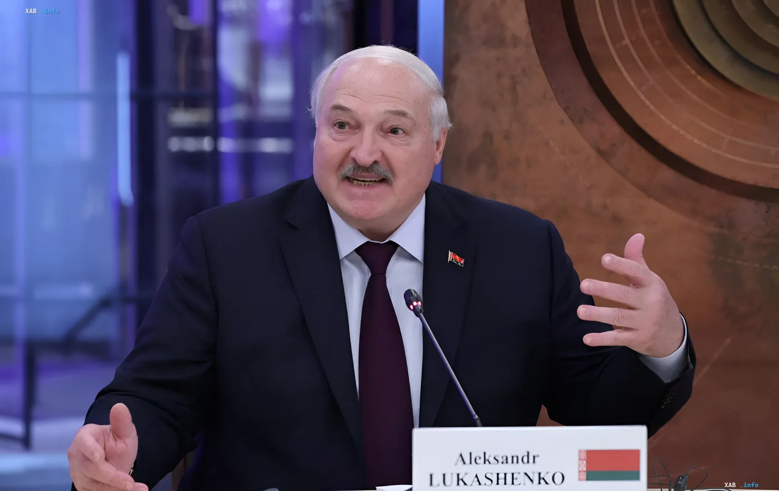 Alexander Lukashenko speaking at a press conference, gesturing with his hand and commenting on the political situation