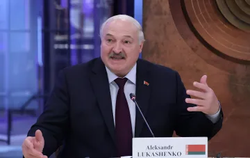 Alexander Lukashenko speaking at a press conference, gesturing with his hand and commenting on the political situation