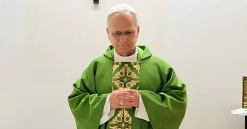 Pope Leo XIV in green vestments and glasses after lung surgery