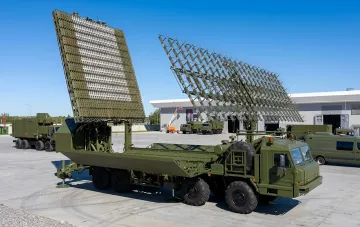 Military radar station complex deployed in an open area on a clear day