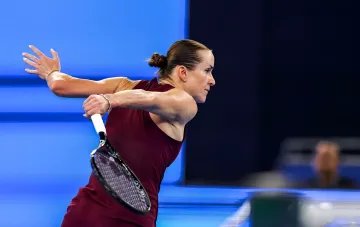 Elina Svitolina executing a powerful tennis shot during a professional match