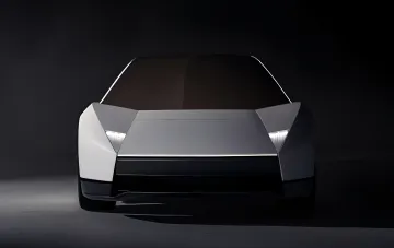 Front view of the futuristic white Tesla Roadster sports electric car in a dark studio