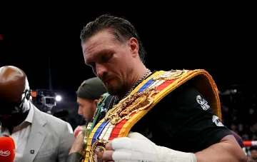 Oleksandr Usyk with championship belts after a victorious heavyweight boxing bout