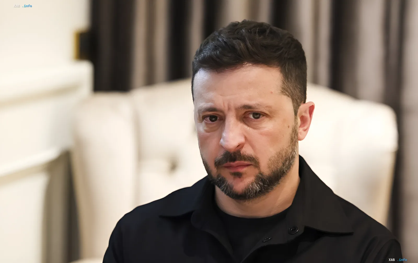 Volodymyr Zelenskyy with a serious expression at a briefing in Brussels while speaking