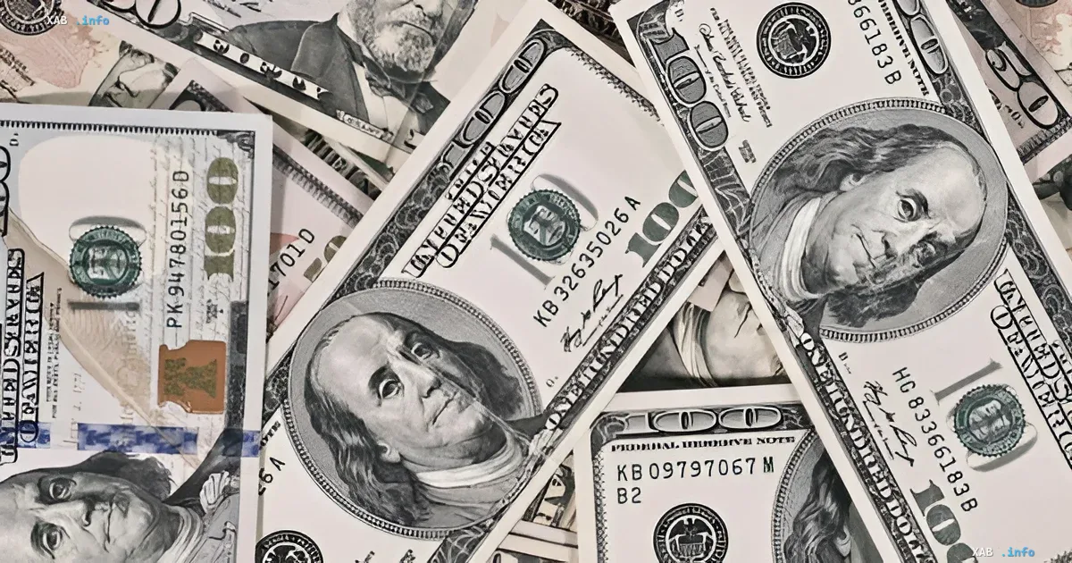 A pile of US one hundred dollar bills lying on a table