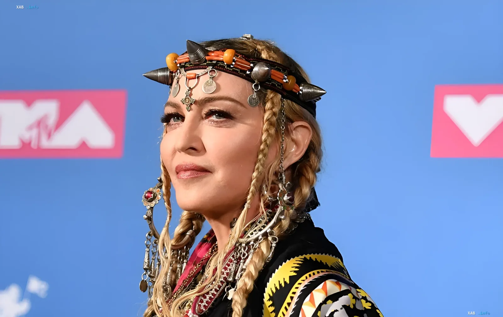 Madonna wearing an ethnic spiked headband and traditional silver jewelry at an event