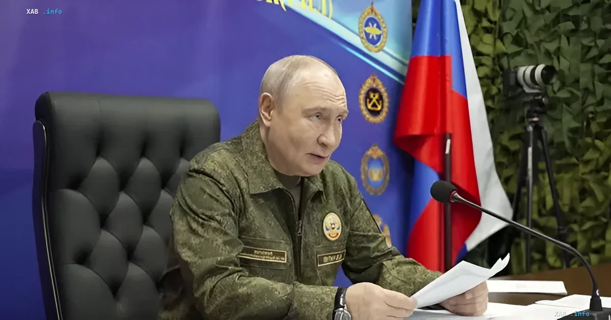 Vladimir Putin in camouflage attire speaking against the background of the official flag
