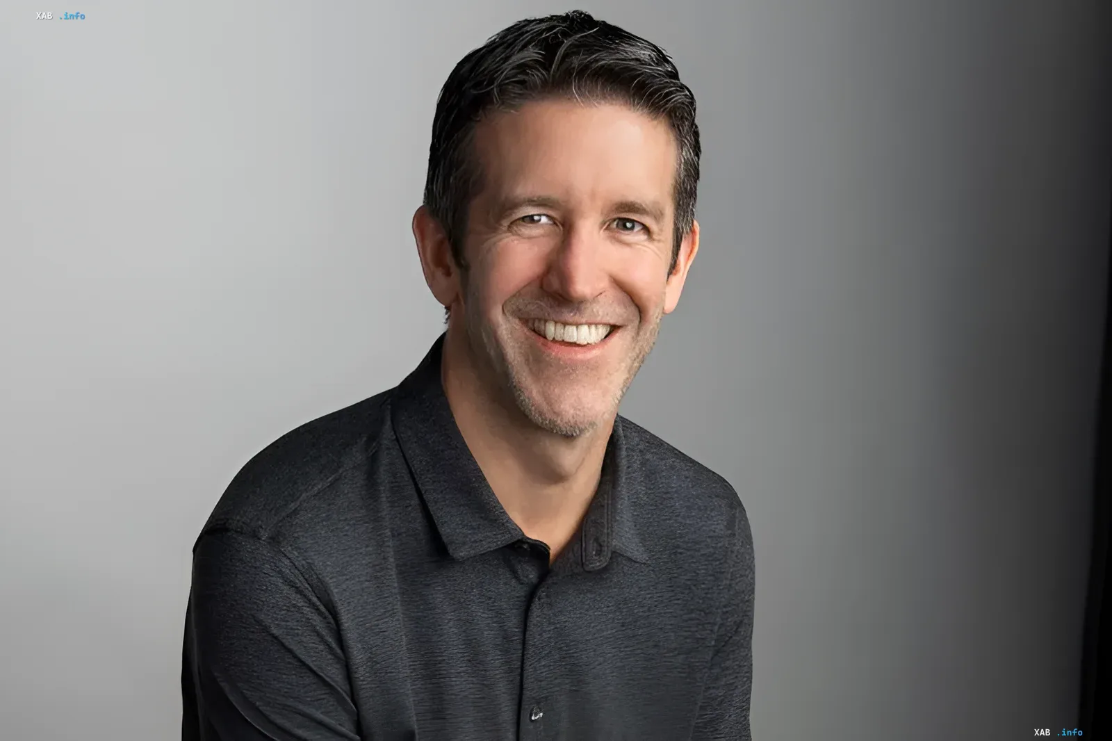 Apple CEO John Ternus smiling during an interview with Time magazine.