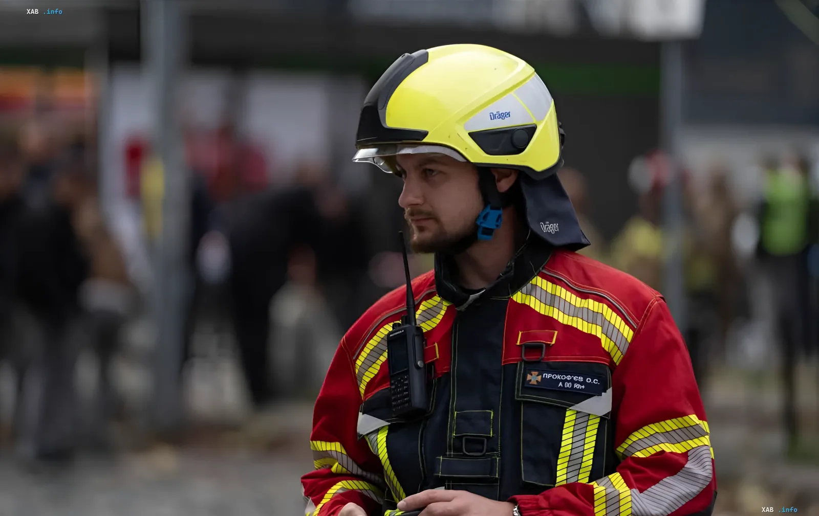 A firefighter in a protective helmet and uniform amid the aftermath of a nighttime attack in Irpin