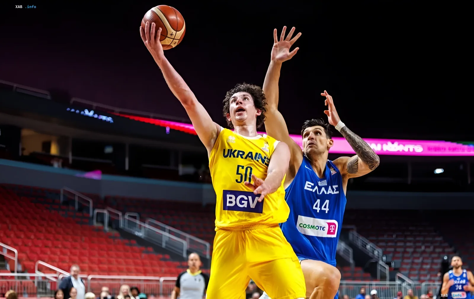Ukrainian basketball player Oleksandr Kovlyar in a yellow jersey attacks the basket during an Adriatic League match