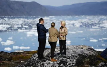 European Commission President Ursula von der Leyen and officials discussing the Arctic strategy against a backdrop of icebergs