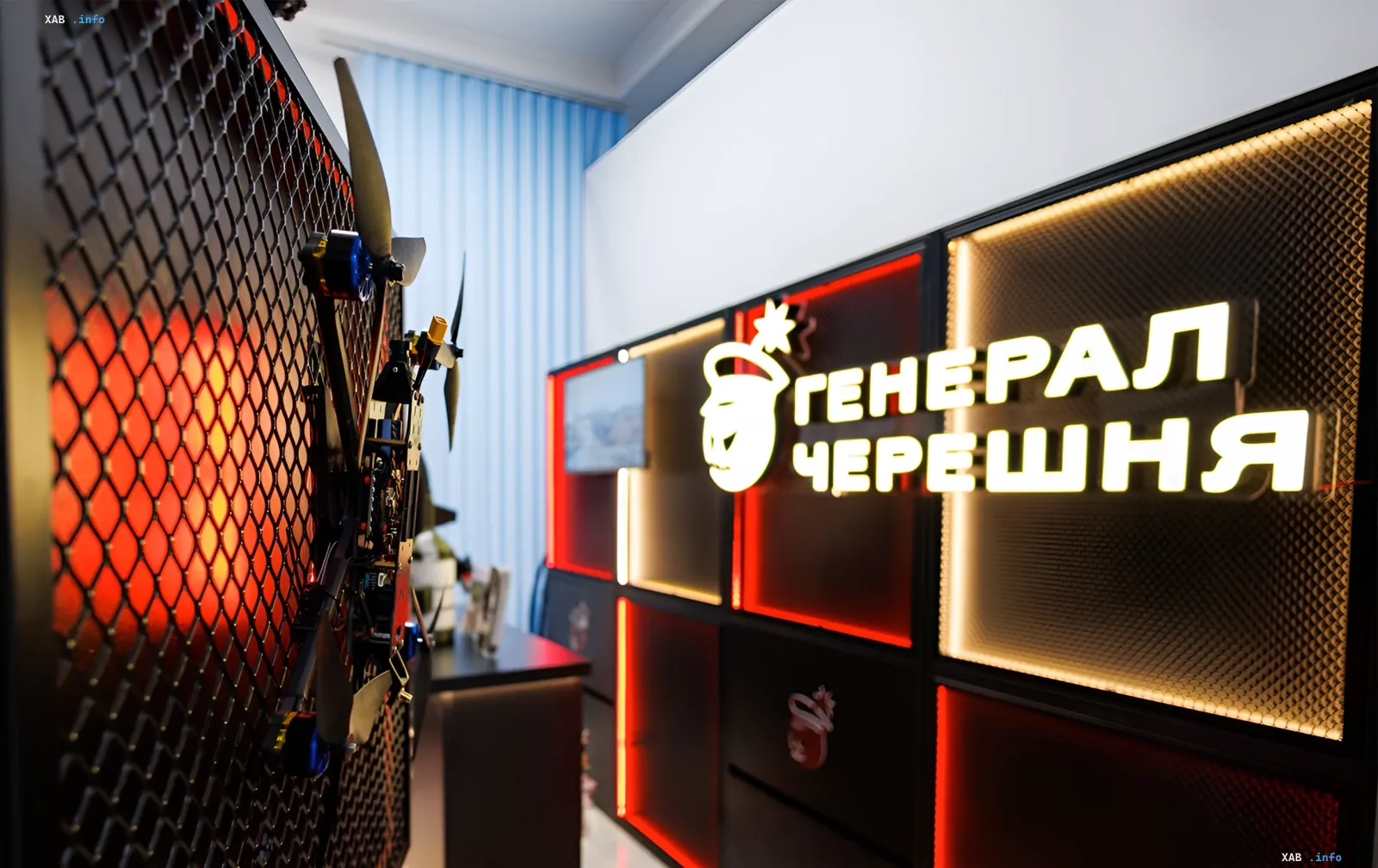 Booth of Ukrainian drone manufacturer General Chereshnya featuring UAV exhibits and a neon sign