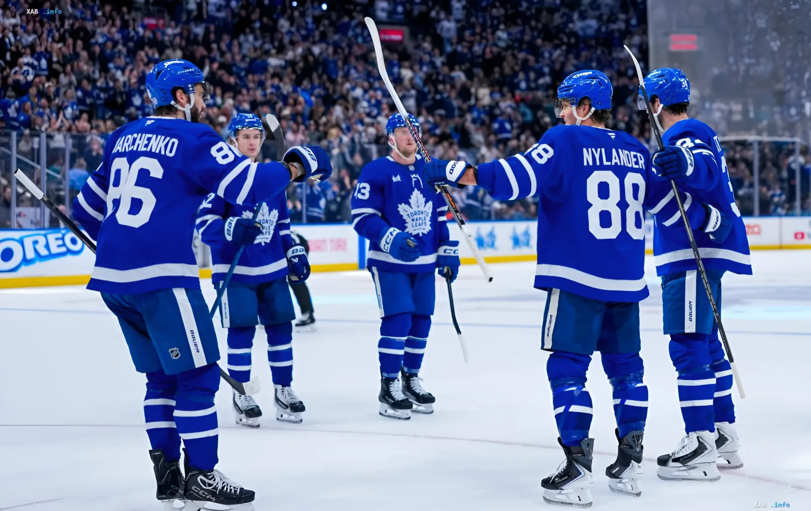 Toronto Maple Leafs hockey players celebrating a victory on the arena ice