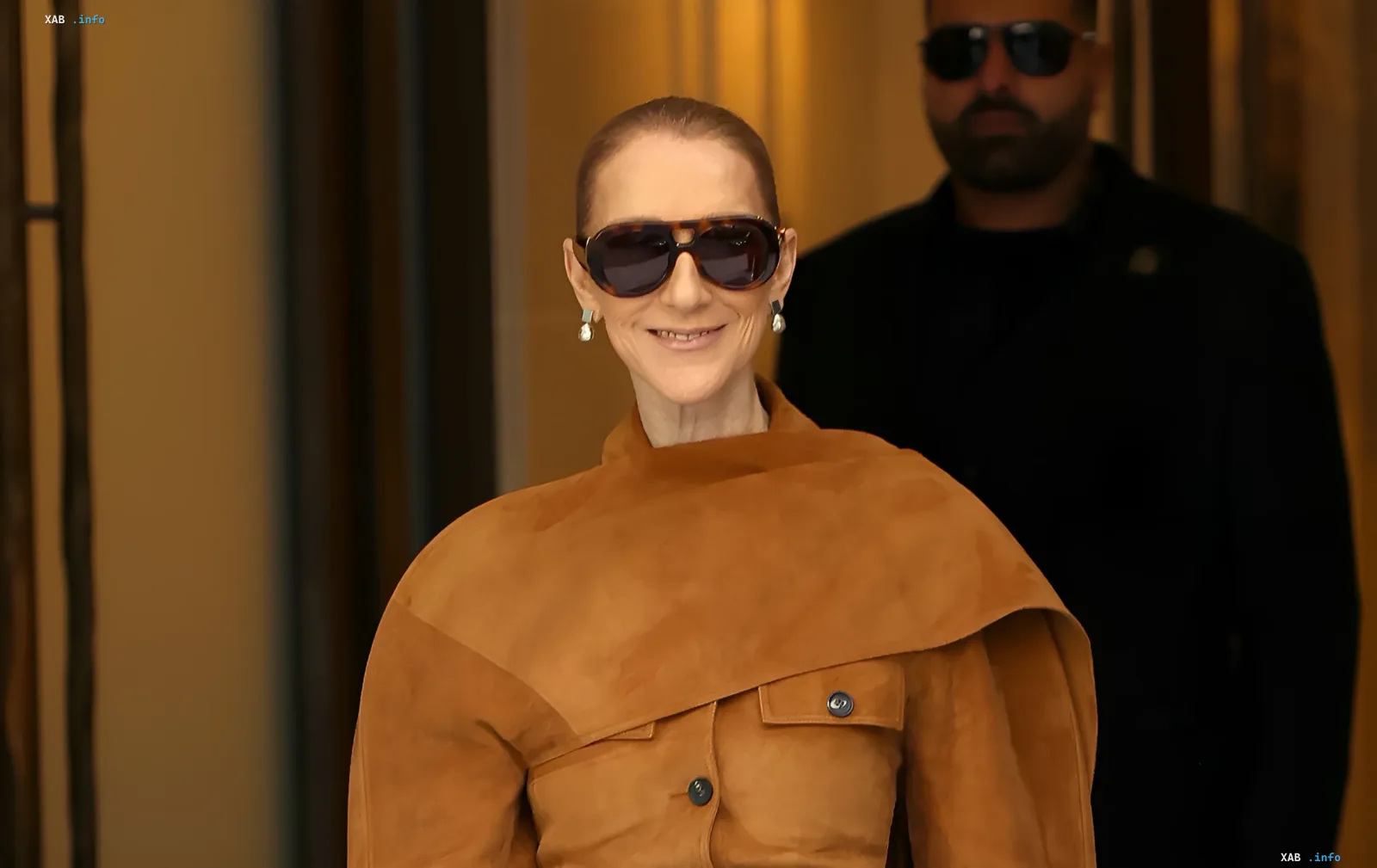 Celine Dion wearing a brown Ferragamo suede outfit and sunglasses in Paris