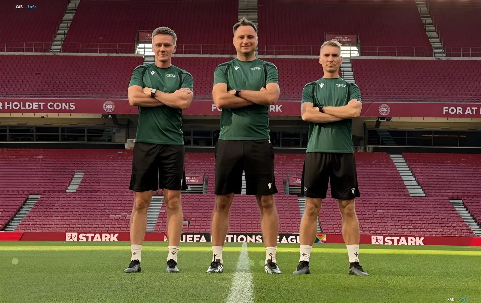 Ukrainian football referee crew headed by Mykola Balakin in green kits on the football pitch
