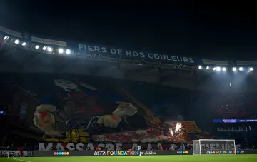 PSG fans unfurled a giant aggressive banner with a chainsaw against Barcelona in the stands of Parc des Princes stadium