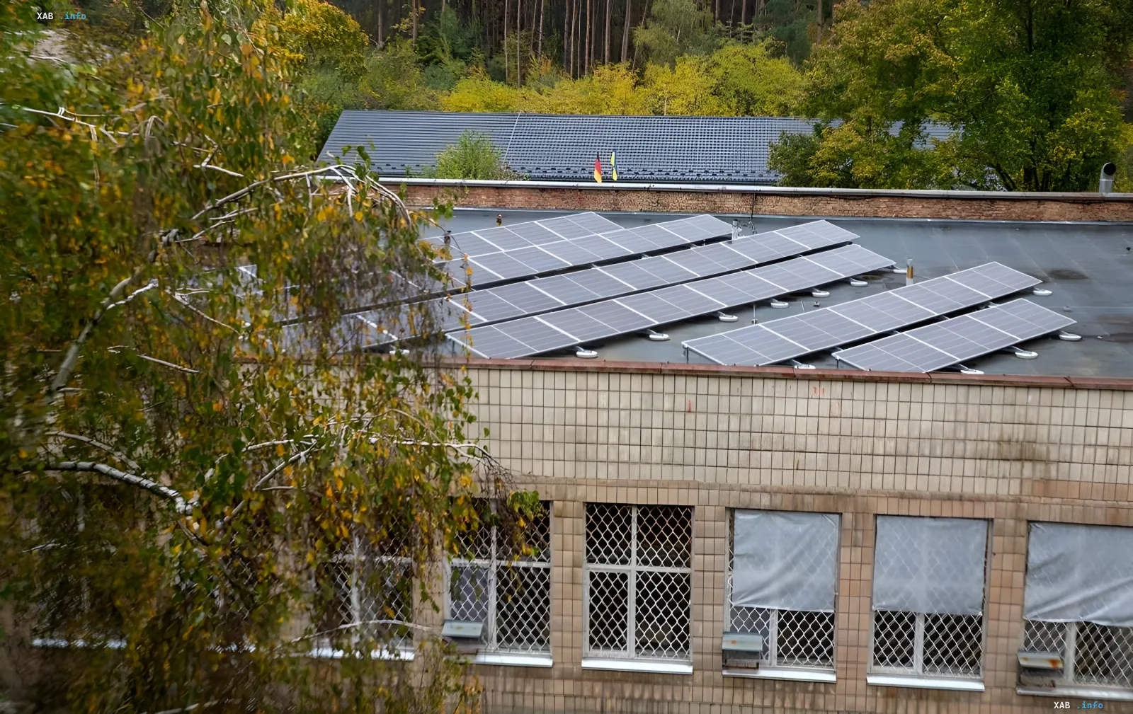 Solar panels on the roof of a social nursing home in Kyiv surrounded by trees