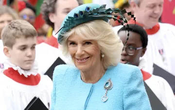 Queen Camilla in a blue outfit and tiara at an event