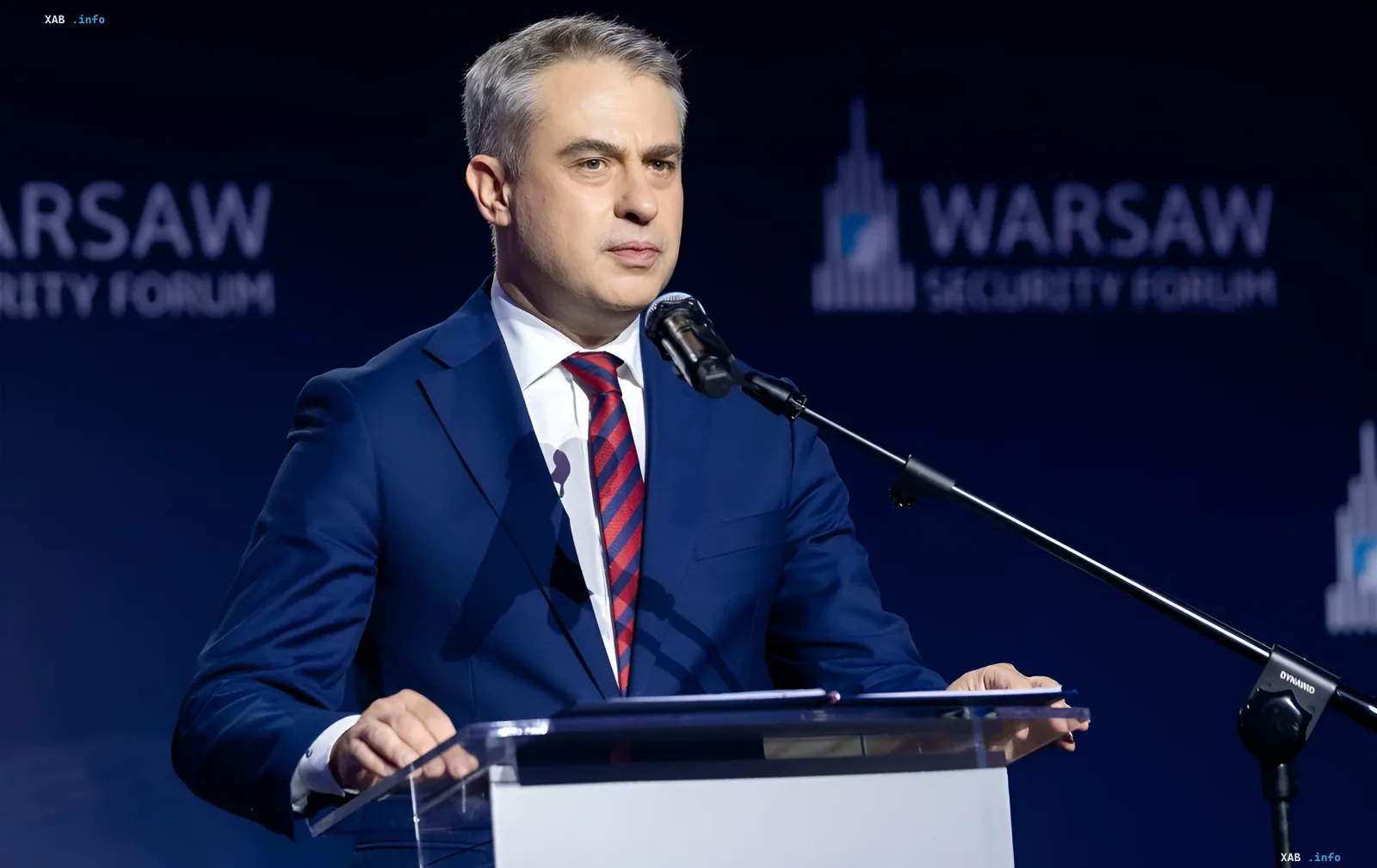A man in a suit speaks at a podium during the Warsaw Security Forum