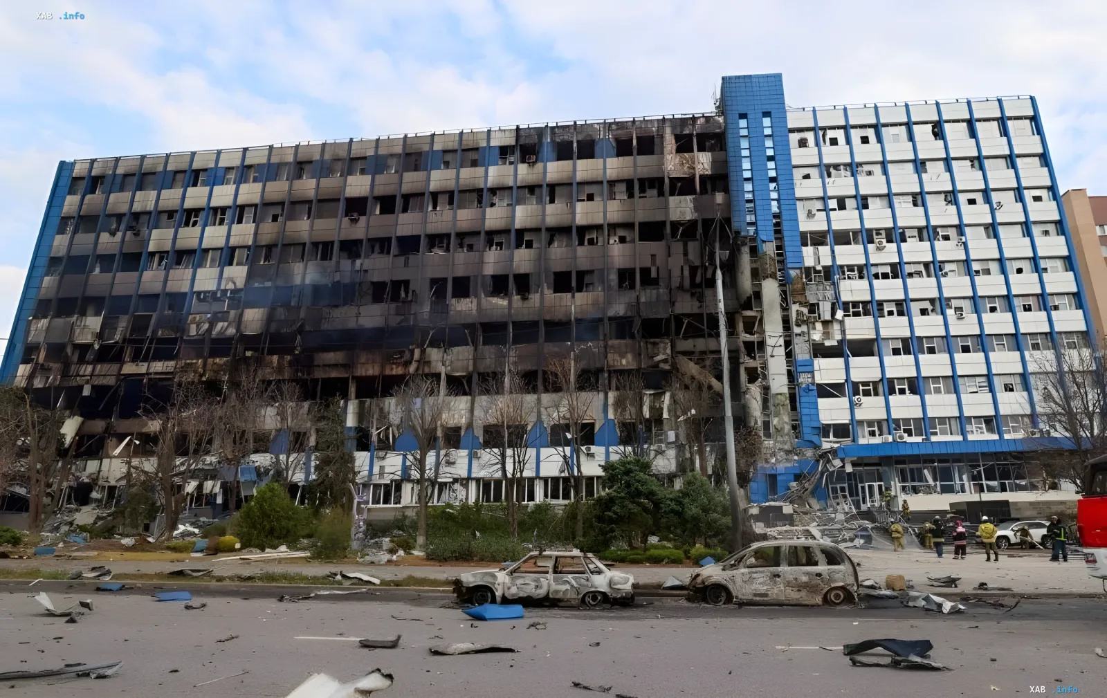 Heavily damaged multi-story communication building after a strike in Donetsk with a burned facade and blown-out windows