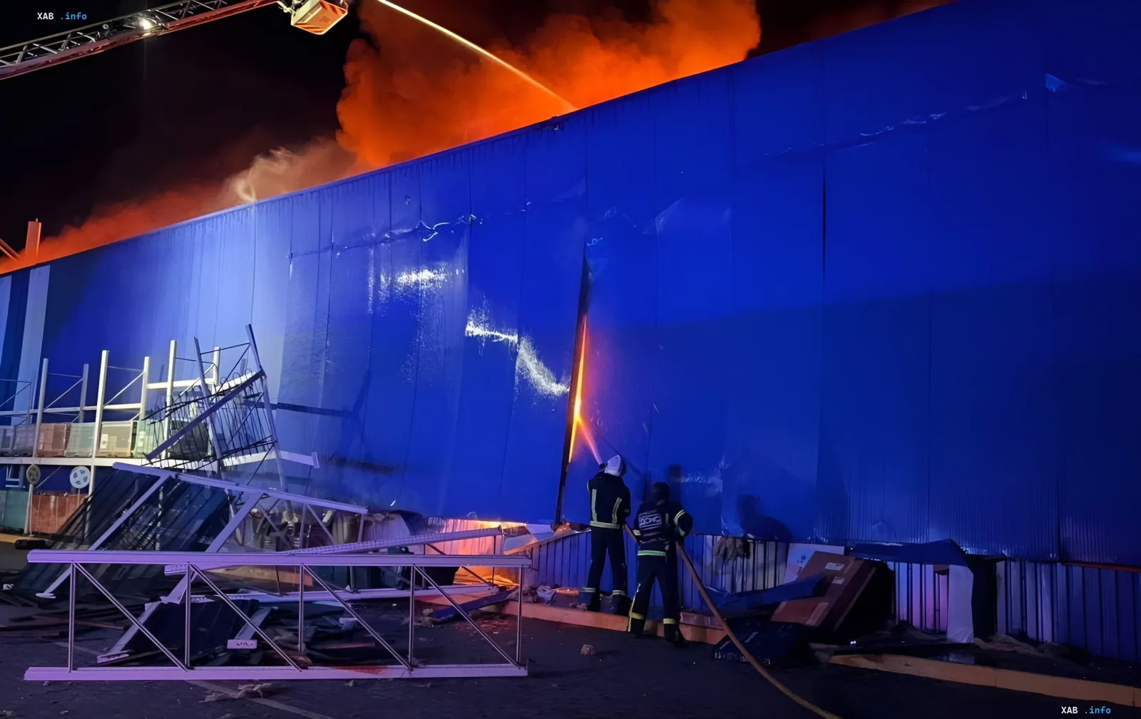 Fire and rescue workers at the site of a night drone strike on a shopping center in Uman