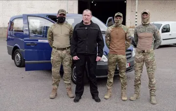 Head of the volunteer headquarters Artur Palatnyi and fighters of the Artan special unit next to the transferred microbus
