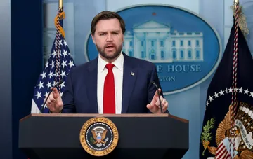 US Vice President JD Vance speaking at a podium in front of the White House seal