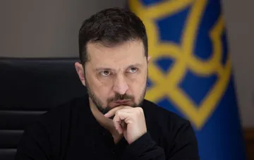 Президент Украины Владимир Зеленский задумчиво слушает во время официального рабочего совещания.