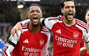 London Arsenal football players celebrate scoring a goal in a match against Everton