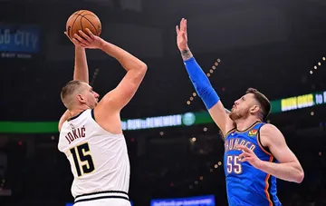 Nikola Jokic of the Denver Nuggets shoots the ball under defensive pressure during an NBA game