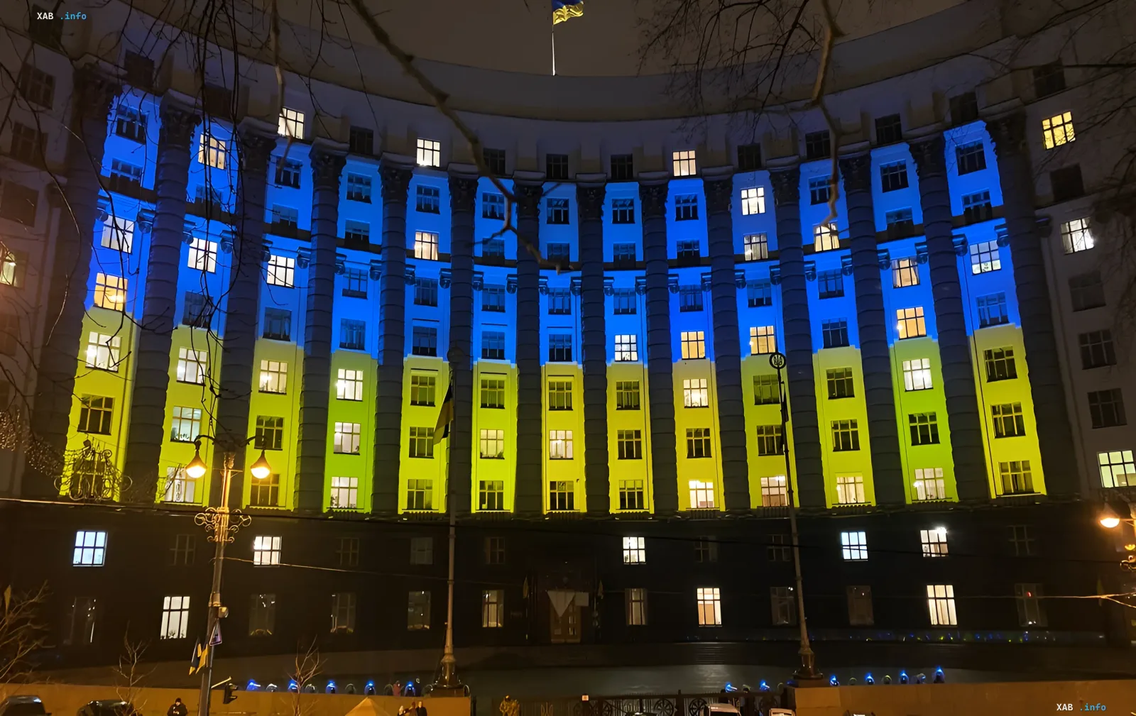 Majestic building of the Ukrainian government illuminated in national flag colors at night