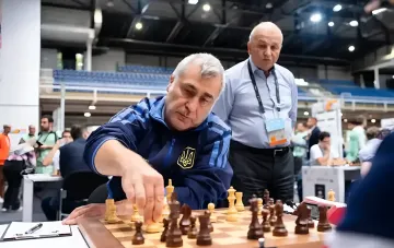 Ukrainian grandmaster Vasyl Ivanchuk makes a move on the chessboard during a competition
