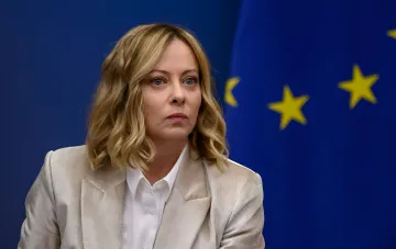 Прем'єр-міністерка Італії Джорджа Мелоні на тлі прапора Європейського Союзу під час офіційного заходу