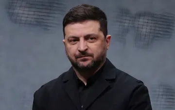 Ukrainian President Volodymyr Zelenskyy in a dark suit during an official speech