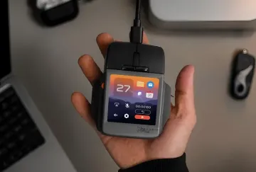 A person holding the Arctic Fox Super Mouse wired computer mouse with a touchscreen