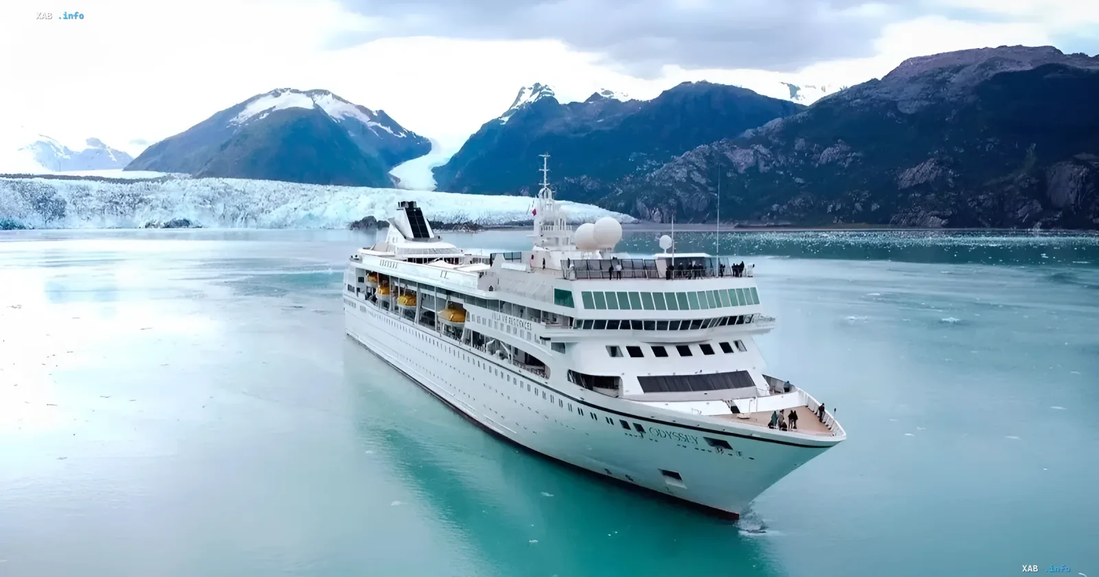 Cruise ship Odyssey in icy waters against the backdrop of majestic mountains and glaciers
