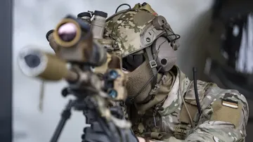 KSK special forces soldier in camouflage gear aiming a rifle during training