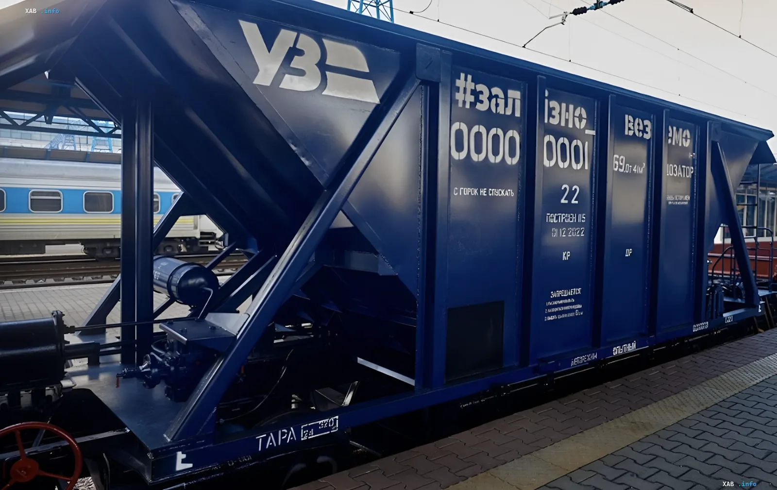 Blue Ukrzaliznytsia freight car parked at a railway station