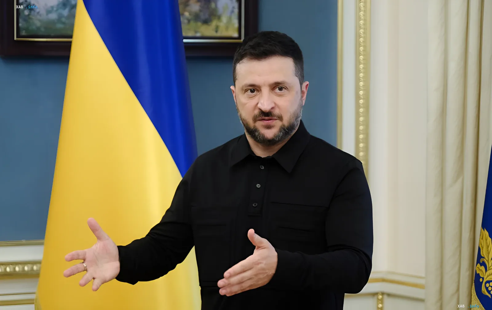 Ukrainian President Volodymyr Zelenskyy speaks against the background of the national flag