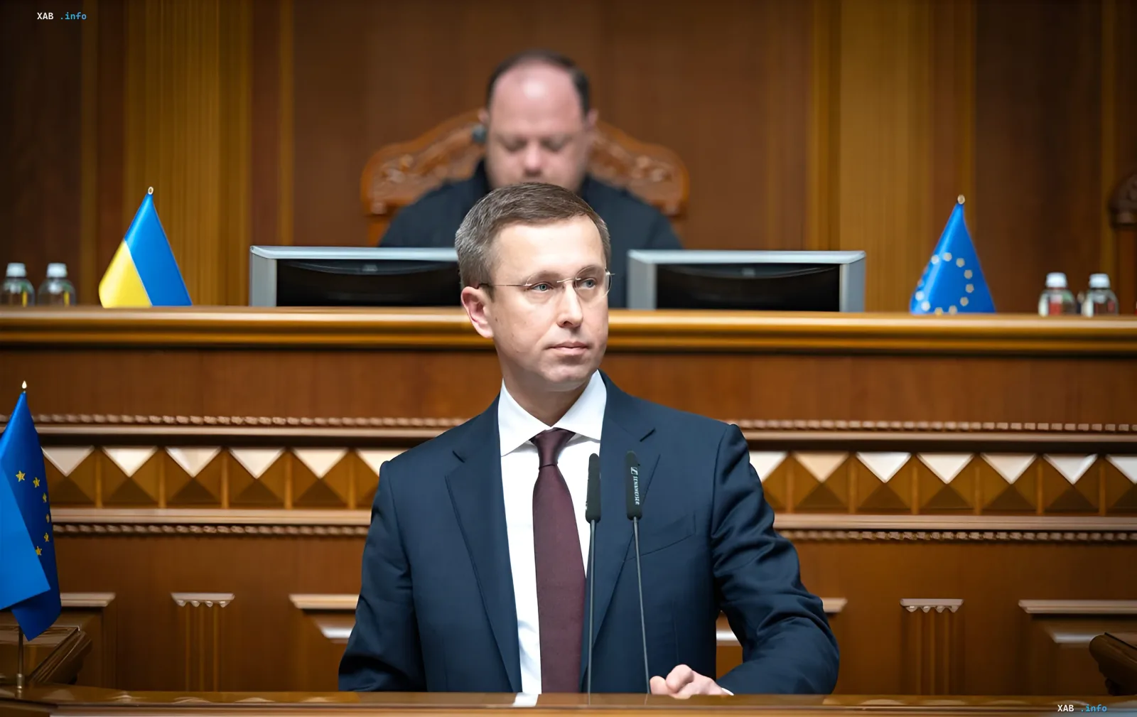 Prime Minister of Ukraine speaking at the podium in parliament during the discussion on evacuation.