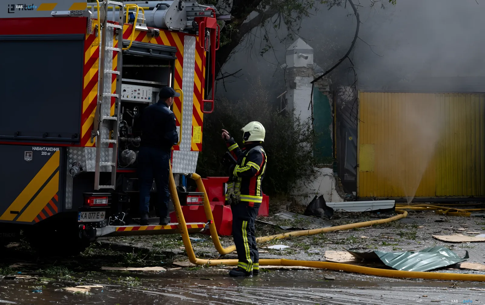 Fire engine and rescuers dealing with the aftermath of the nighttime strike on an enterprise in Kremenchuk