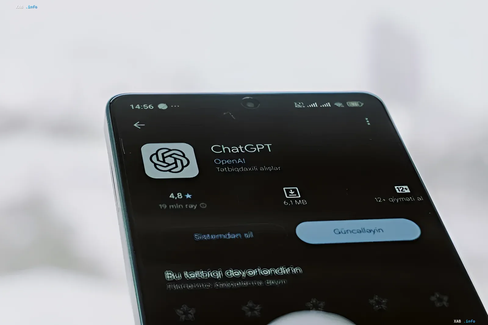 Smartphone in hands displaying the OpenAI ChatGPT mobile application interface on screen